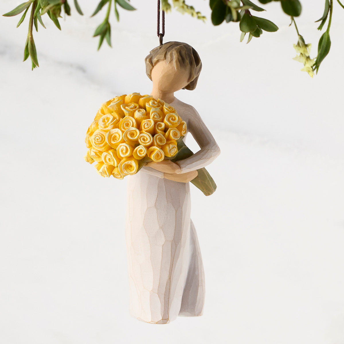 Figure in cream dress, holding large bouquet of yellow roses. Hook and loop affixed to figure's head