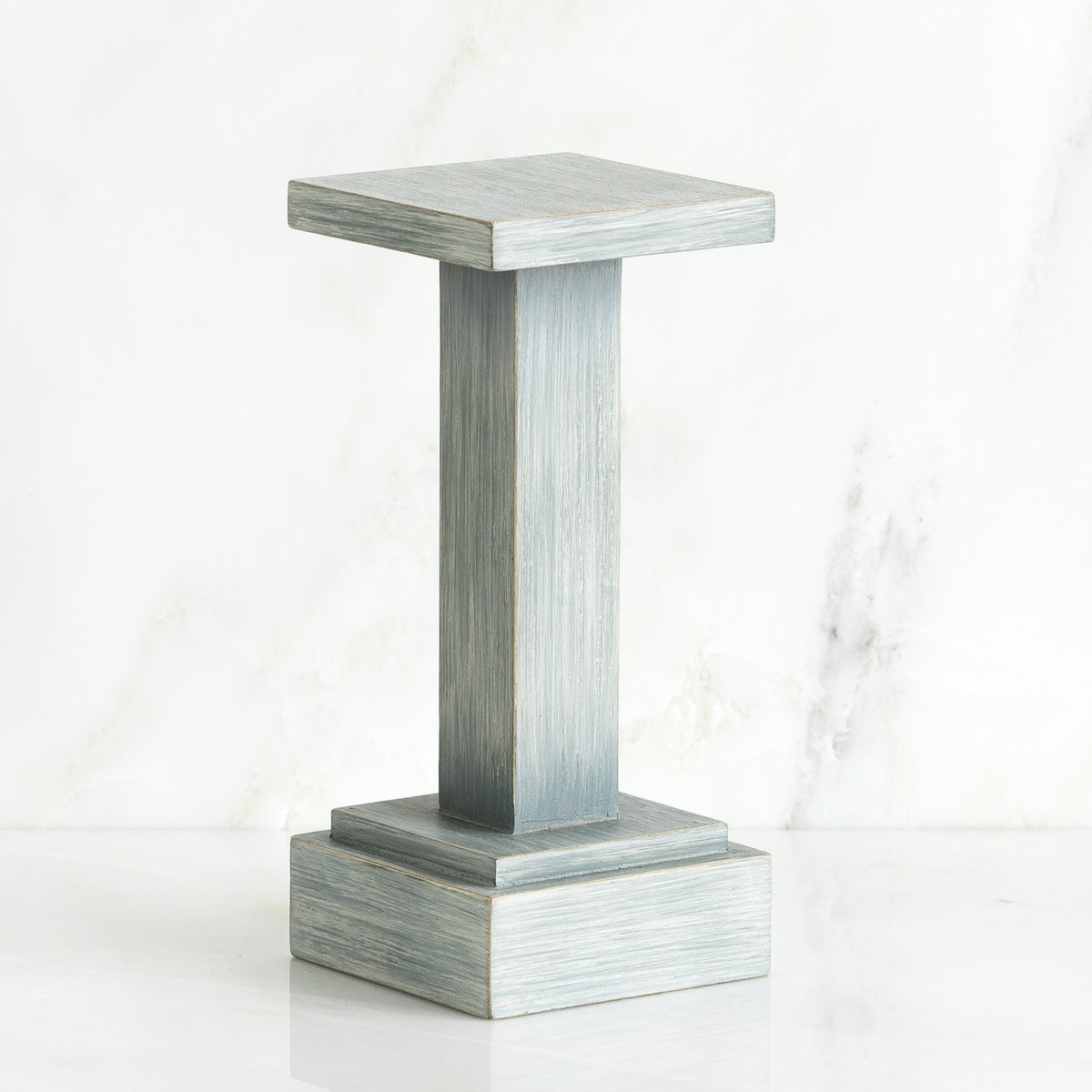 Standing white wooden pedestal stand against white background
