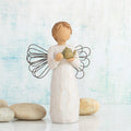 Willow Tree Angel of the Kitchen, 5.5”h hand-painted standing resin figure in cream dress with wire wings, holding green teapot, in front of sky blue painting