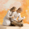 Willow Tree New Life, 5”h hand-painted resin figure of seated couple in neutral colors, holding newborn baby wrapped in cream blanket in front of orange painting