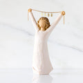 Front view: figure in cream dress holding gold chain above her head with year 2025 on it