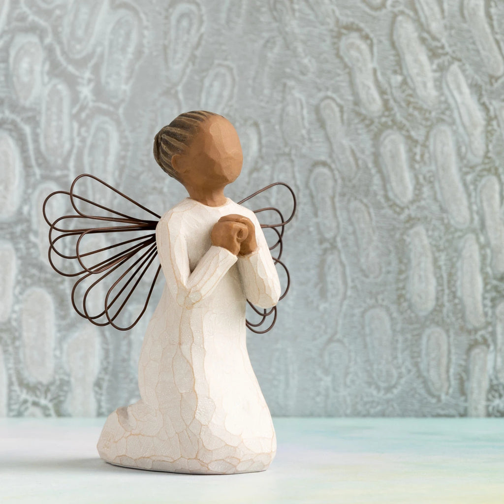 Willow Tree Angel of the Spirit, 4"h hand-painted resin kneeling figure with darker skin and hair, cream dress with wire wings, looking upwards with hands in prayer position. Silver painting in background