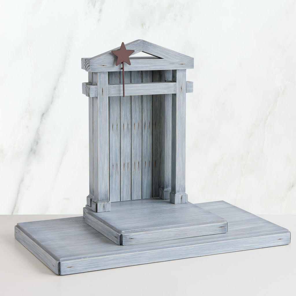 Grey barn standing up on stand with brown star on it