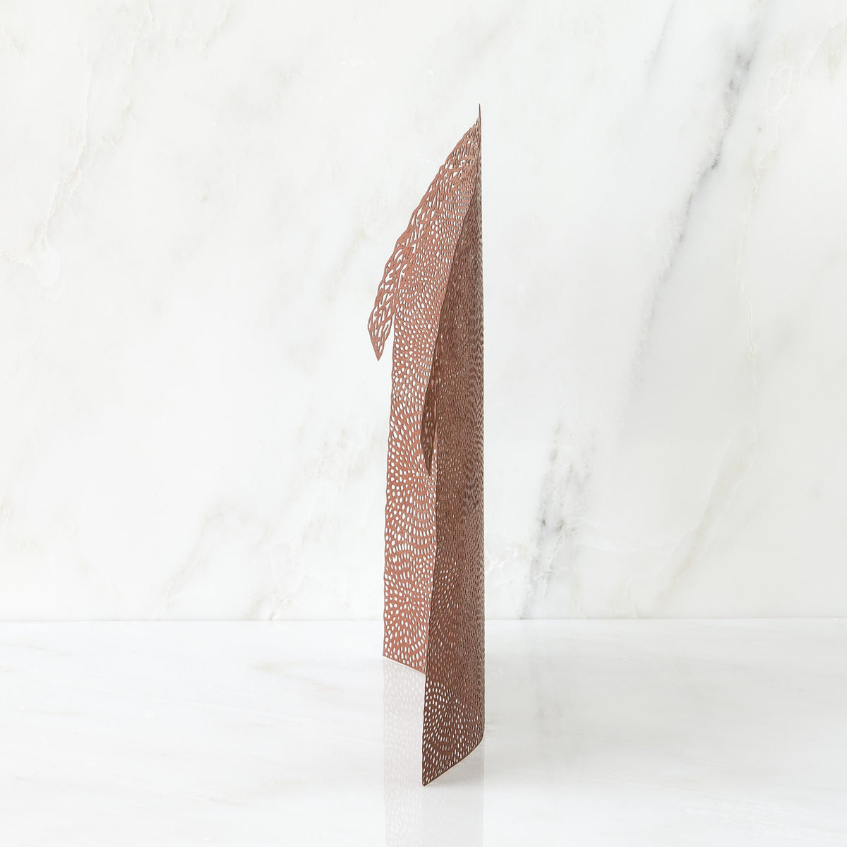 Brown figurine standing up against white background