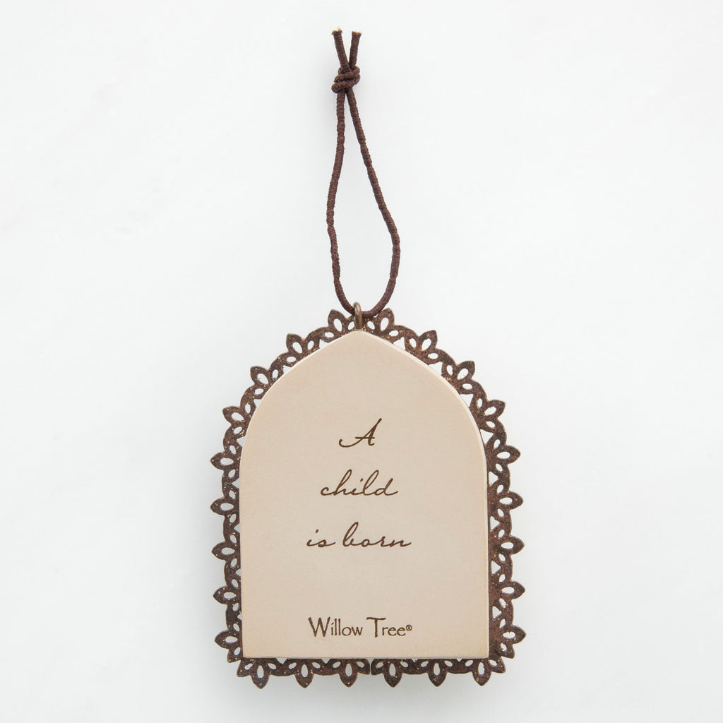 Round cream pendant with wooden outline - center says 'a child is born'