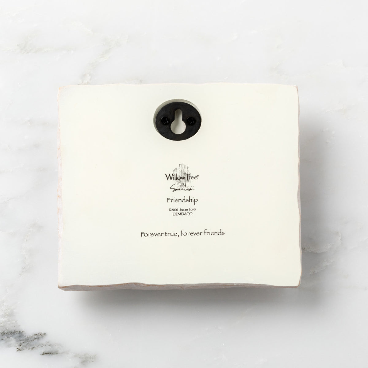 Back of white plaque reading piece title and sentiment, with Willow Tree logo