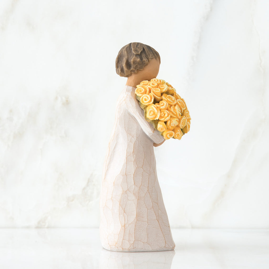 Left side view of little girl with short brown hair holding a large bouquet of yellow roses