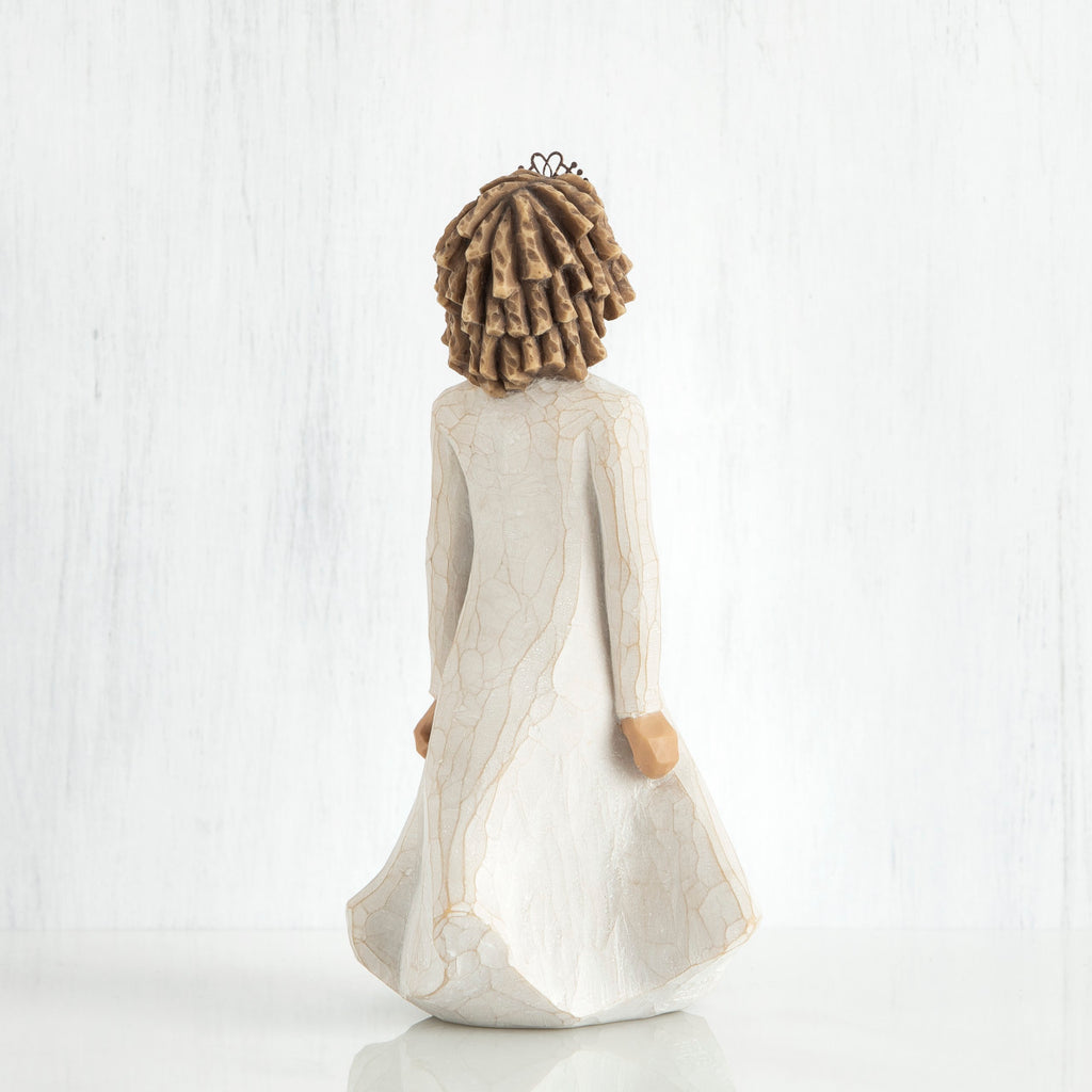 Back view of curly hair girl figurine in white dress standing up