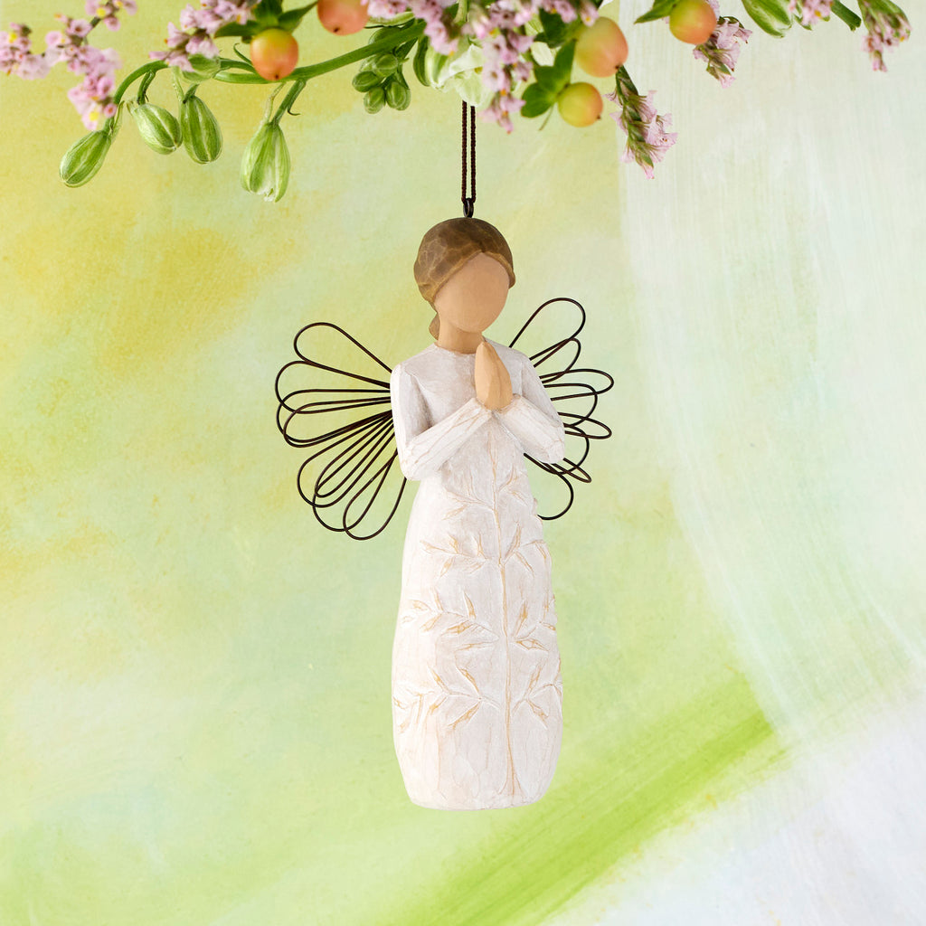 Willow Tree a tree, a prayer Ornament, 4”h hand-painted resin angel figure in cream dress with wire wings, hands in prayer position, tree carving on dress, brown elastic cord, hanging in front of lime painting