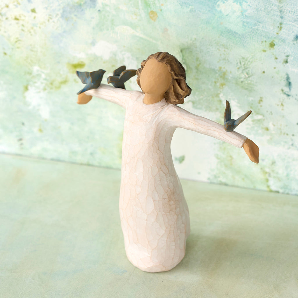 Willow Tree Happiness, 5.5”h hand-painted standing resin figure in cream dress, three bluebirds perched on outstretched arms, in front of light green painting